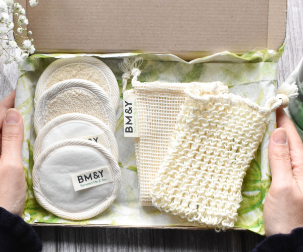 four white reusable makeup remover pads and one sisal soap saver