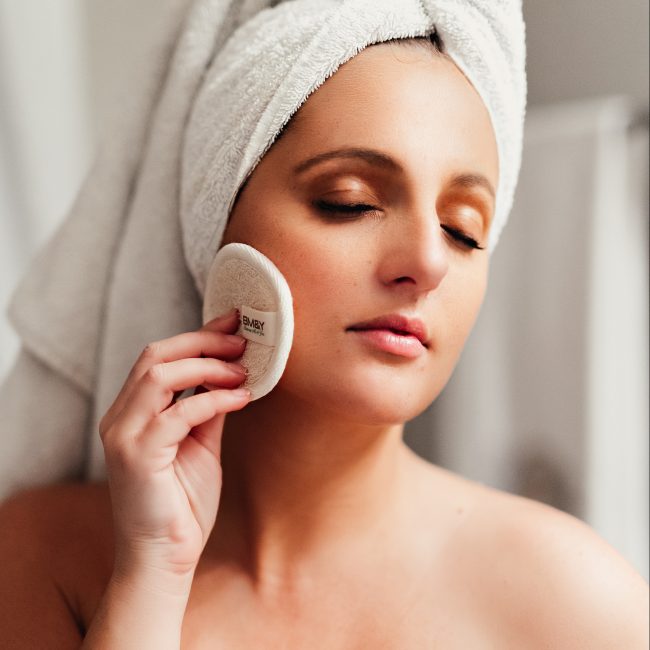 white woman using a textured BM&Y reusable bamboo cotton pad
